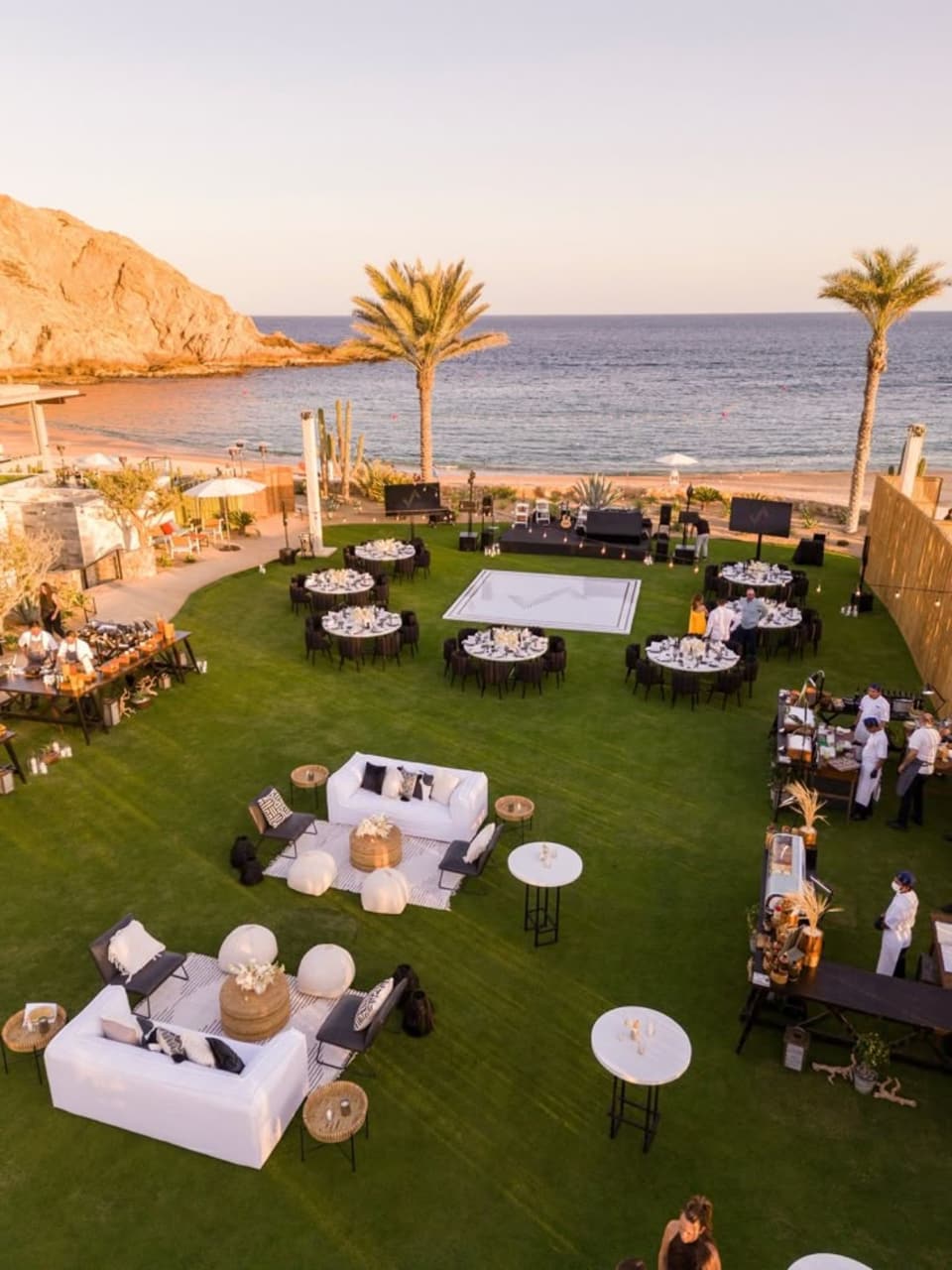 A coastal event with guests at long tables